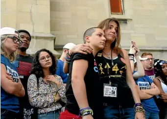  ?? AP ?? Parkland student activist Emma Gonzalez, centre left, hugs Patricia Oliver before a peace rally and march in Chicago. Oliver’s son, Joaquin Oliver, was shot and killed at a Florida high school.