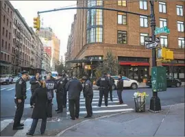  ?? Drew Angerer Getty Images ?? POLICE GATHER near Robert De Niro’s TriBeCa Production­s in New York. A retired detective screening mail for De Niro discovered the suspicious package.