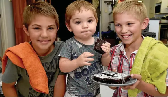  ??  ?? TREAT TIME: Enjoying a treat are (from left) James Shum, Darcy Dowe and Blake Shum. The young boys have started a business making and selling brownies.