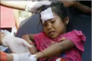  ?? FIRDIA LISNAWATI — THE ASSOCIATED PRESS ?? A girl injured in an earthquake is treated in Mataram, Lombok, Indonesia, Thursday. The Indonesian island of Lombok was shaken by a third big earthquake in little more than a week Thursday.