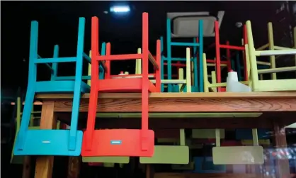  ?? Photograph: Ina Fassbender/AFP via Getty Images ?? Chairs on tables at a closed restaurant during a lockdown.