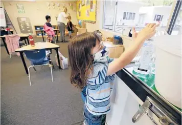  ?? AL SEIB/LOS ANGELES TIMES 2020 ?? Student Jackson Middleton uses hand sanitizer in the classroom in Palos Verdes, California.