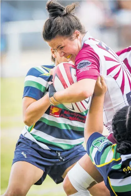  ?? Photo / Paul Taylor ?? Taradale centre Michaela Baker is sandwiched by two Hastings Rugby and Sports defenders during Saturday’s Hawke’s Bay Sevens tournament in Waipukurau.