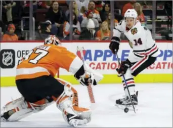  ?? MATT SLOCUM — THE ASSOCIATED PRESS ?? The Blackhawks’ Richard Panik, right, tries to get a shot past Flyers’ goalie Brian Elliott in the first period Thursday. Not much got past Elliott on the night though, the goalie making 38 saves to key a 3-1 victory at Wells Fargo Center.
