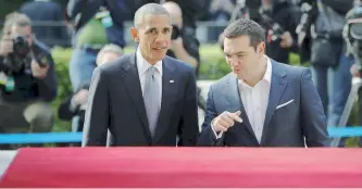  ??  ?? Outgoing US President Barack Obama walks into the Maximos Mansion with Greek Prime Minister Alexis Tsipras yesterday (top). Obama’s convoy passes through central Athens yesterday (bottom). Security has been ramped up for the historic visit.