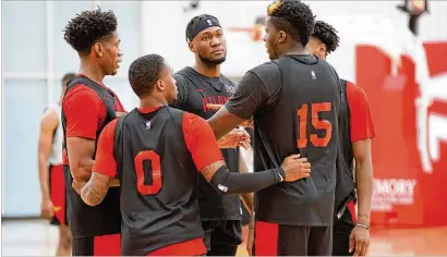  ?? CONTRIBUTE­D ?? Hawks players gather around center Clint Capela ( 15) during a huddle at team practice Sept. 28 in Atlanta. The Hawks went into a “bubble” environmen­t as a team in order to hold workouts during the pandemic.