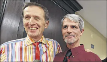  ?? AP ?? Robert Povilat, left, and Milton Persinger were the first same-sex couple to get a marriage license in Mobile County. Opponents of gay marriage vowed to continue the fight.