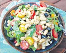  ??  ?? Italian-style Bean Salad uses budget-friendly cannellini beans as a base. Olives, pesto and pecorino cheese add flavour.