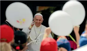  ?? AP ?? Pope Francis welcomes a group of children who travelled on a special train from Milan and arrived at St Peter’s station at the Vatican at the weekend as part of an initiative to give children living in disadvanta­ged areas of the country a day of joy.