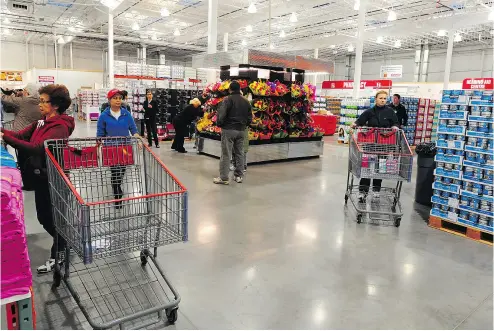  ?? BRUCE EDWARDS / EDMONTON JOURNAL ?? Food sales have been critical to Costco Canada’s success and the competitio­n is not expected to let up. “It’s still very good for Costco and Walmart, but ... we are seeing more competitiv­e pricing from grocery,” one analyst says.