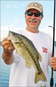  ??  ?? Henry Snuggs of Badin, N.C., is all smiles after catching this trophy Lake Greeson spotted bass on live crawfish bait.