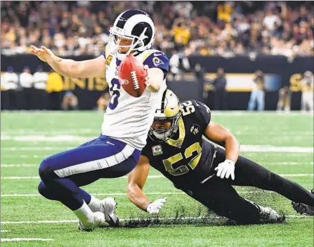  ?? Wally Skalij Los Angeles Times ?? RAMS’ Johnny Hekker extends his left arm to get the necessary yards for a first down as Saints linebacker Craig Robertson defends on the fake field-goal attempt. Officials marked it one yard short but replays show Hekker might have got the ball to the first-down stripe.