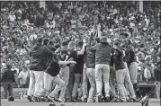  ?? [AP PHOTO] ?? Milwaukee Brewers players celebrate after defeating the Chicago Cubs 3-1 at the end of a tiebreak baseball game on Monday in Chicago.