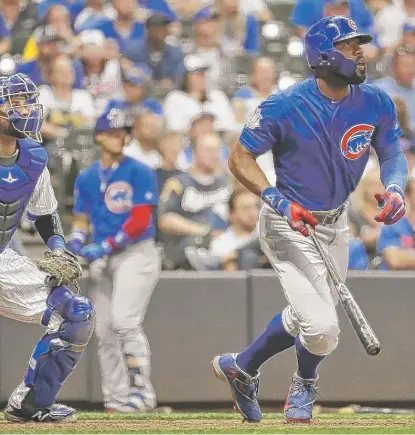  ??  ?? Jason Heyward follows the flight of his home run off Brewers reliever Jared Hughes in the 11th inning Saturday night. | MORRY GASH/ AP Kyle Hendricks allowed one run and six hits in five- plus innings.