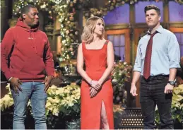  ??  ?? Scarlett Johansson hosts “Saturday Night Live” on Dec. 14, 2019, performing a monologue that includes Michael Che, left, and her fiancé, Colin Jost.