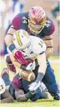  ?? MARK WALLHEISER/AP ?? DeMarcus Walker strips the ball from Chattanoog­a running back Derrick Craine.