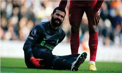  ?? Photograph: Martin Rickett/PA ?? Alisson feels the pain during the 1-1 draw with Manchester City on Saturday. The Liverpool No 1 is expected to be out for at least two weeks.