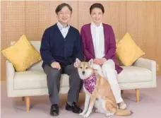  ?? — Reuters ?? Japan’s Crown Princess Masako and her husband Crown Prince Naruhito pose for a photograph with their pet dog Yuri at Togu Palace in Tokyo.