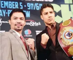  ?? FREDERIC J BROWN/AFP ?? Manny Pacquiao (left) and Jessie Vargas pose for pictures during a press conference in Beverly Hills on September 8.