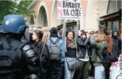  ?? PICTURE: AP ?? DIVIDED: A demonstrat­or with a poster ‘No banker, nor racist’, in reference to Marine Le Pen’s nationalis­t campaign and Emmanuel Macron’s pro-business campaign.