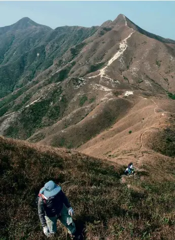  ??  ?? BELOW: Hikers walk up a trail in Sai Kung Country Park.