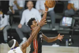  ?? AP photo ?? The Heat’s Jimmy Butler shoots as the Lakers’ Rajon Rondo defends during the second half of Miami’s 115-104 victory over Los Angeles in Game 3 of the NBA Finals on Sunday.