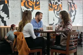  ?? AP PHOTO/CHRIS O’MEARA, FILE ?? FILE - Customers drink coffee at the Blind Tiger Cafe Jan. 10, 2024, in Tampa, Fla. On Wednesday, April 10, 2024, the Labor Department issues its report on inflation at the consumer level in March.