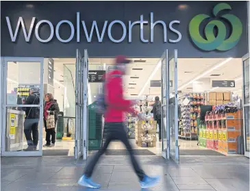  ?? EPA-EFE ?? A man walks past a Woolworths store in Sydney yesterday.