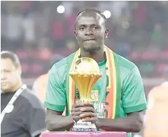  ?? ?? Senegal’s inspiratio­nal player, Sadio Mane with the AFCON trophy the Teranga Lions won in 2021