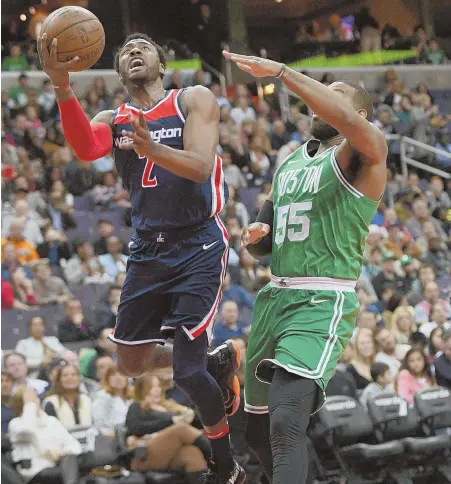  ?? AP PHOTO ?? CAN’T CAPITALIZE: Greg Monroe can only watch as the Wizards’ John Wall sails to the hoop for a layup during the Celtics’ 113-101 loss last night in Washington.