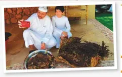  ??  ?? Sultan Bin Mejren and his son opening one of the sacks of the meat prepared through unique tanoor process.