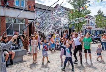  ?? ?? FUN DAY: Children enjoy the Groovy Bubble Popping Madness in Hanley. All pictures by Steve Bould