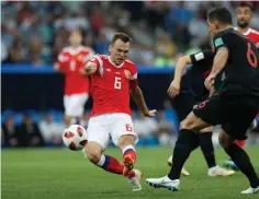  ?? Associated Press ?? ■ Russia's Denis Cheryshev scores his side's opening goal during the quarterfin­al match between Russia and Croatia at the 2018 World Cup on Saturday in the Fisht Stadium in Sochi, Russia.