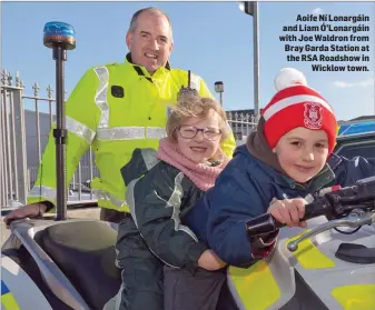  ??  ?? Aoife Ní Lonargáin and Liam Ó’Lonargáin with Joe Waldron from Bray Garda Station at the RSA Roadshow in Wicklow town.