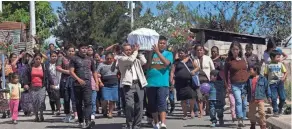  ?? ASSOCIATED PRESS ?? Relatives and friends carry the coffin containing the remains of youth shelter fire victim Siona Hernandez, 17, to the home of Siona’s mother in Ciudad Peronia, Guatemala, on Friday.