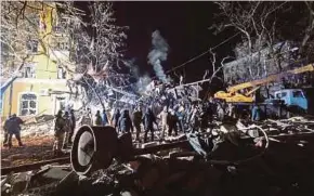  ?? EPA PIC ?? Rescuers looking for survivors following a rocket attack on a residentia­l building in the city of Kramatorsk, Donetsk, Ukraine, on Wednesday.