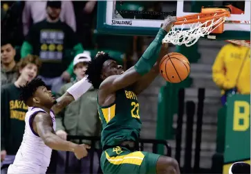  ?? ASSOCIATED PRESS ?? Baylor forward Jonathan Tchamwa Tchatchoua (23) dunks over Alcorn State guard Paul King in the second half of an NCAA college basketball game, Monday, Dec. 20, 2021, in Waco, Texas.