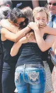  ??  ?? GRIEVING: Family members and friends hug after the funeral of Elyse Miller-Kennedy (inset right).