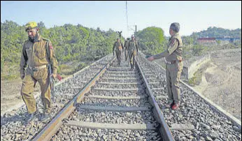  ?? ANI PHOTO ?? Police personnel inspecting the tracks after three siblings jumped from a railway bridge, in Jammu on Wednesday. The children were on their way to school in Bajalta.