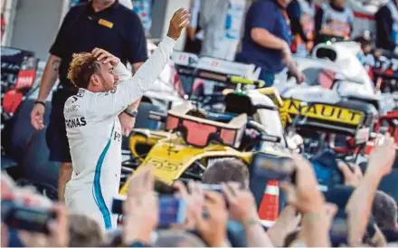  ?? EPA PIC ?? Mercedes AMG Petronas driver Lewis Hamilton reacts after winning the Japanese Grand Prix yesterday. Retirement­s: