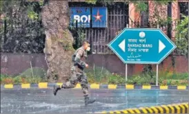  ??  ?? A man runs for cover during a storm at Sansad Marg on Sunday. A spell of rain and hail lashed parts of NCR on Sunday, providing much-needed respite from the hot weather.