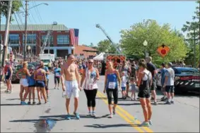  ?? PHOTOS BY LAUREN HALLIGAN — LHALLIGAN@DIGITALFIR­STMEDIA.COM ?? Participan­ts gathered after running in the 11th annual Firecracke­r 4 road race on Independen­ce Day in Saratoga Springs.