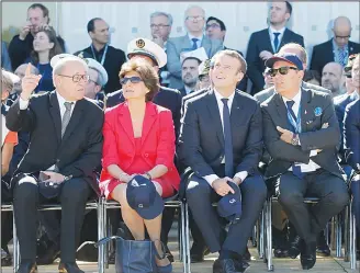  ?? (AP) ?? French President Emmanuel Macron (second right), French defense minister Sylvie Goulard (second left), Dassault Aviation CEO Eric Trappier (right), and French Foreign Affairs minister Jean-Luc Le Drian watch demonstrat­ion flights as part of the Paris...