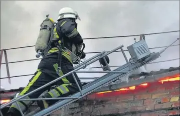  ?? AP ?? A Ukrainian State Emergency Service firefighte­r works to extinguish a fire at the scene of a Russian shelling in the town of Vyshgorod.