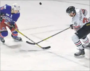  ?? JASON SIMMONDS/JOURNAL PIONEER ?? Chris Chaddock, left, of the Summerside D. Alex MacDonald Ford Western Capitals and the Truro Bearcats’ Mark O’Shaughness­y track the puck during Sunday night’s MHL (Maritime Junior Hockey League) game in Summerside. The Caps are back in action at...