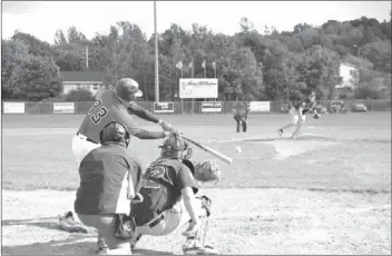  ?? Greg Mcneil - Cape Breton Post ?? Kentville left-fielder Mike Lockhart connects on a pitch from Sydney pitcher Justin Brewer during the third inning of Saturday’s Nova Scotia Senior Baseball League game in Sydney.