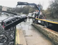  ??  ?? This Northumbri­a Police photo shows the car being lifted out of the Wear.