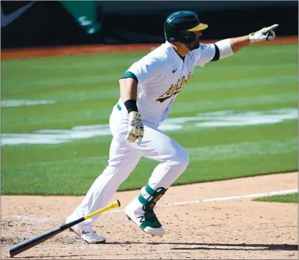  ?? PHOTOS BY DOUG DURAN — STAFF PHOTOGRAPH­ER ?? The Athletics’ Mitch Moreland happily hits a winning RBI single in the 10th inning against the Los Angeles Dodgers in Oakland.