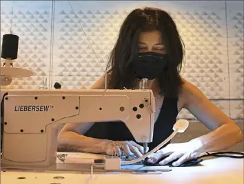  ?? Peter Diana/Post-Gazette ?? Diana Misetic, owner of the East Eight Co., sews face masks at her new McKees Rocks warehouse.