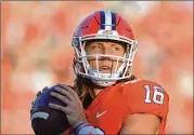  ?? HYOSUB SHIN / HYOSUB.SHIN@AJC.COM ?? If you’re a probable high draftee such as Clemson QB Trevor Lawrence, would you risk your future by playing football in March/April/May?